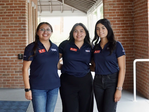 three women in navy shirts at Old Main