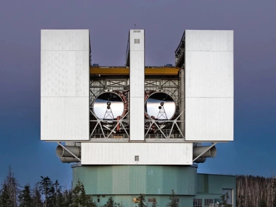 The Large Binocular Telescope stands tall above the treetops.