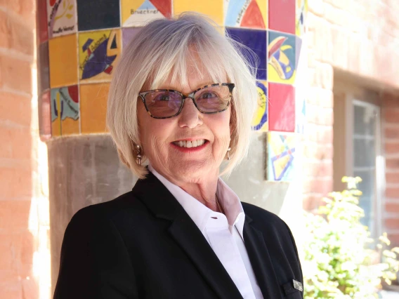 portrait of Claudia Nelson wearing white shirt and black blazer