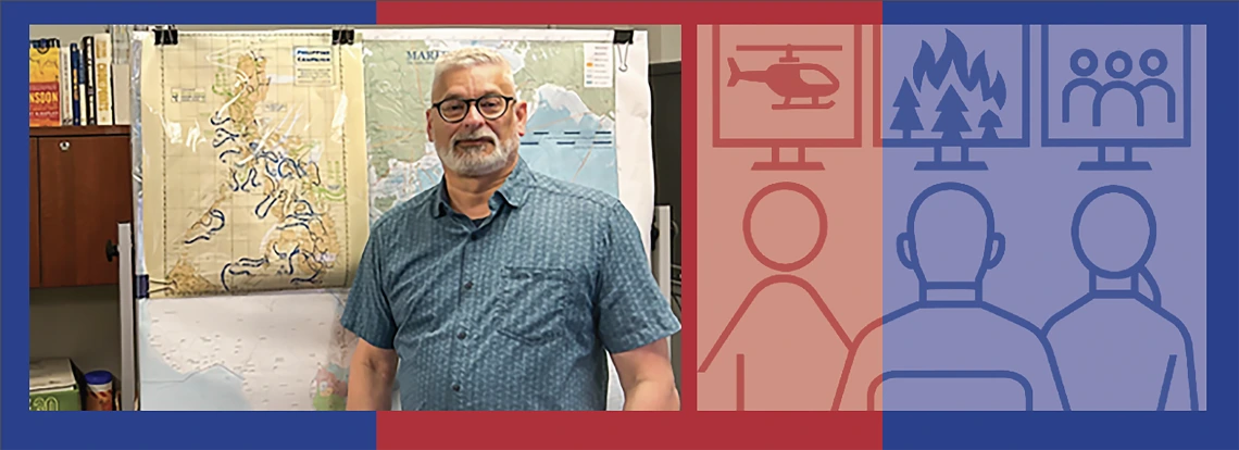 White haired man in front of maps